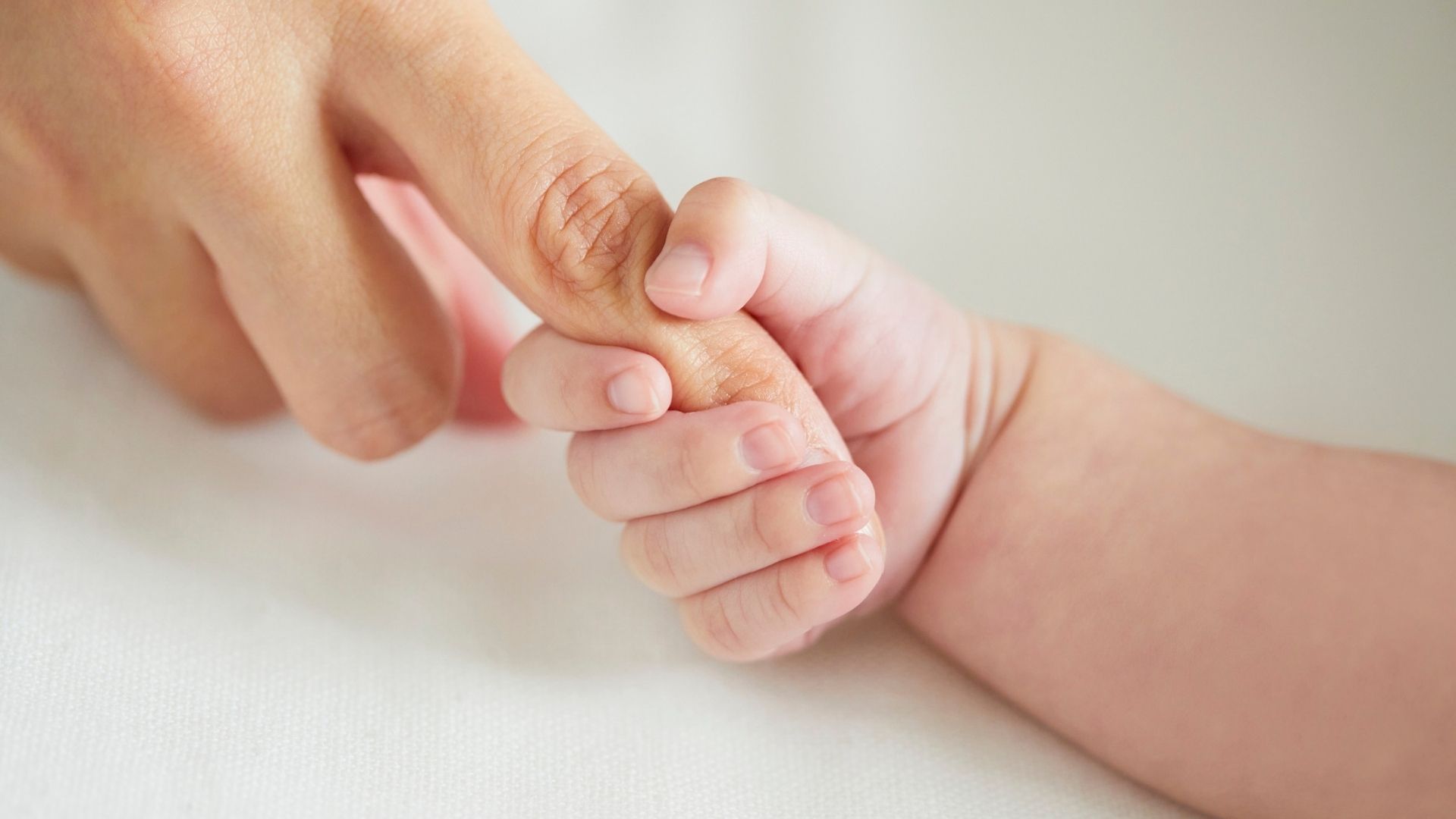 A newborn held close